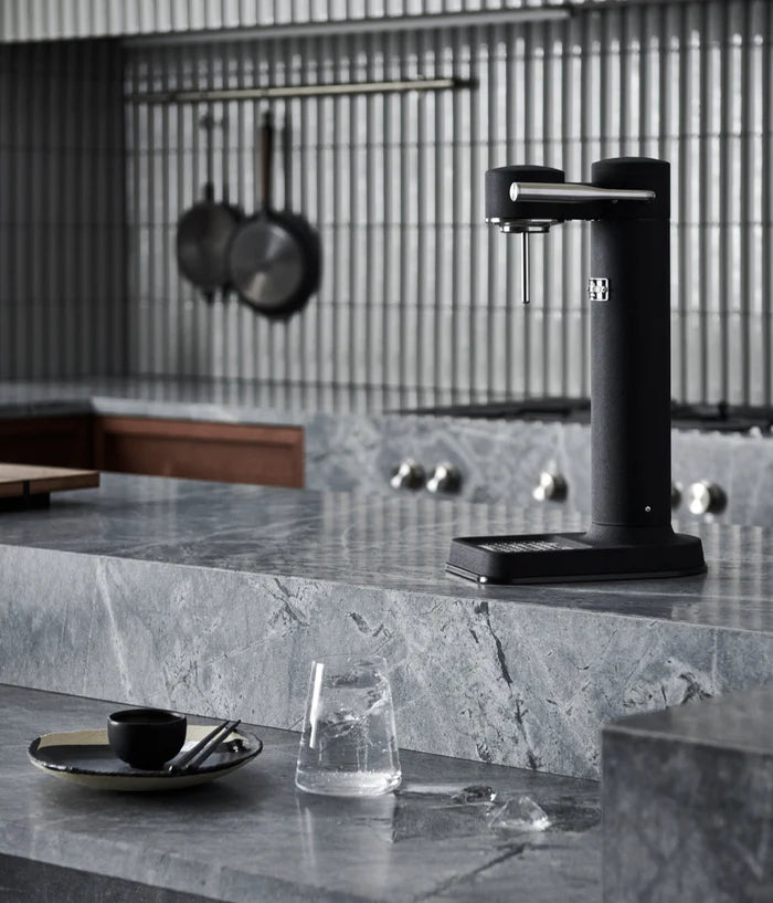 Aarke Carbonator 3 Matte Black with sparkling water glass