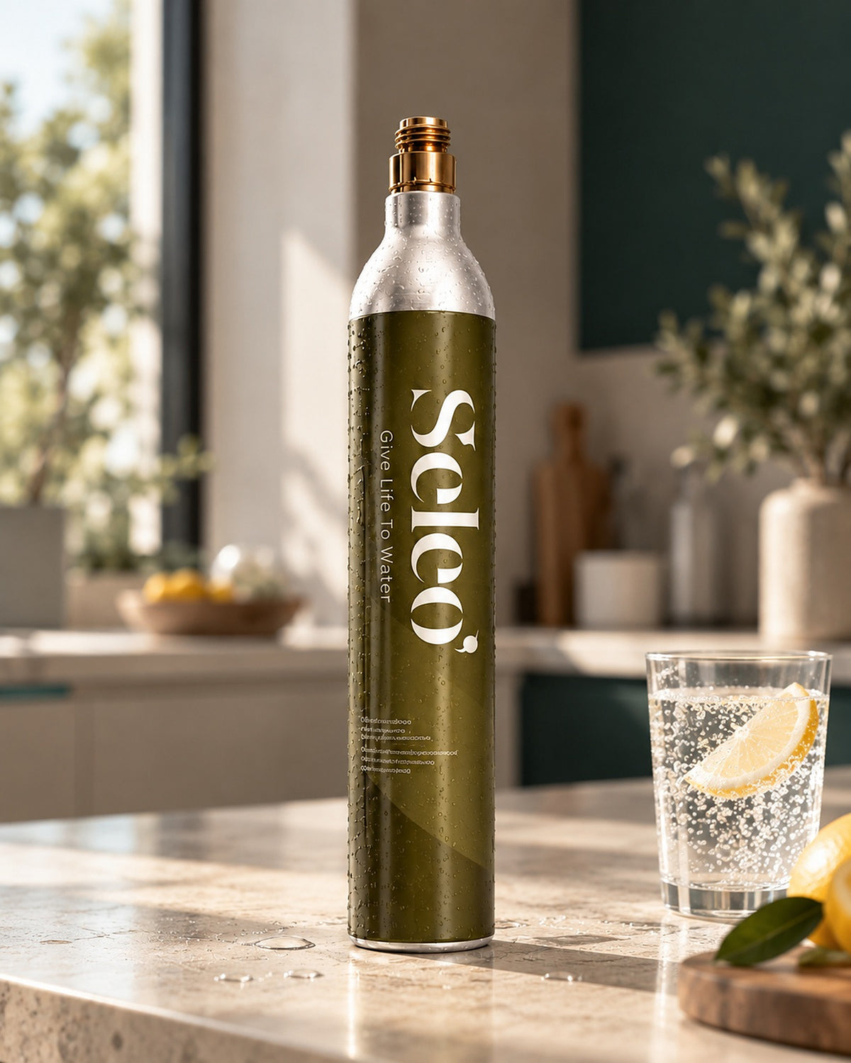 Seleo CO2 gas cylinder on a kitchen counter next to a glass of sparkling water with lemon