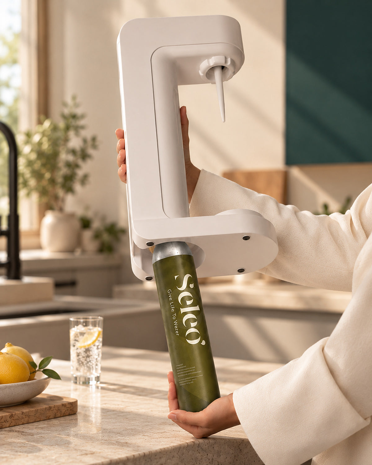 Seleo CO2 cylinder being fitted into the base of a white home soda maker in a bright kitchen